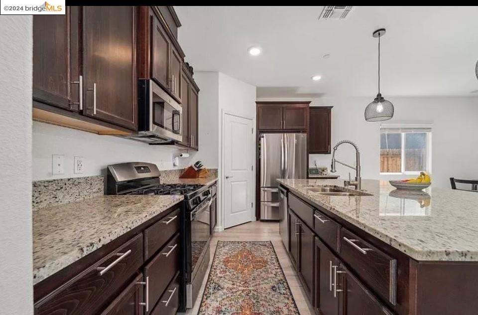 1749 Botticelli Way Lodi, CA 95242 - Photo 2 of 24 a kitchen with stainless steel appliances granite countertop a sink stove and refrigerator