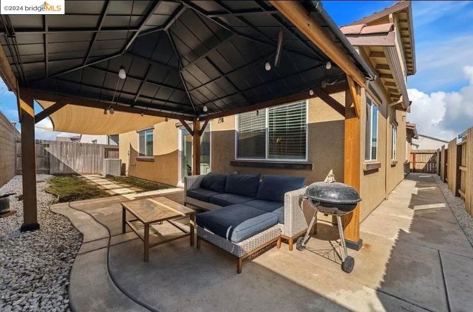 1749 Botticelli Way Lodi, CA 95242 - Photo 24 of 24 a outdoor living space with patio furniture and a umbrella