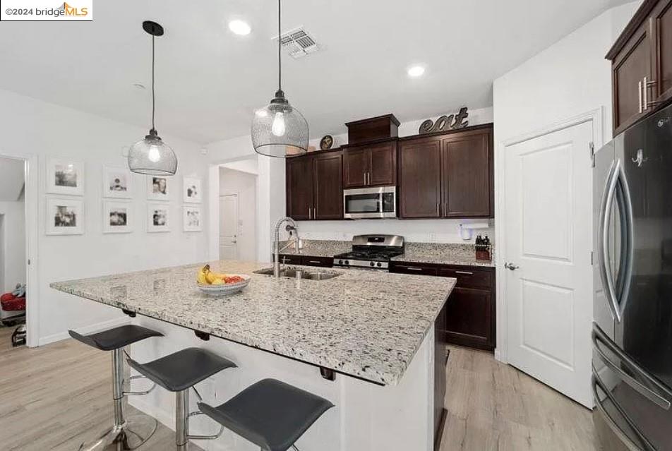 1749 Botticelli Way Lodi, CA 95242 - Photo 3 of 24 a kitchen with kitchen island a counter space a sink appliances and cabinets