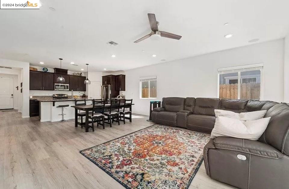 1749 Botticelli Way Lodi, CA 95242 - Photo 7 of 24 a living room with furniture and kitchen view