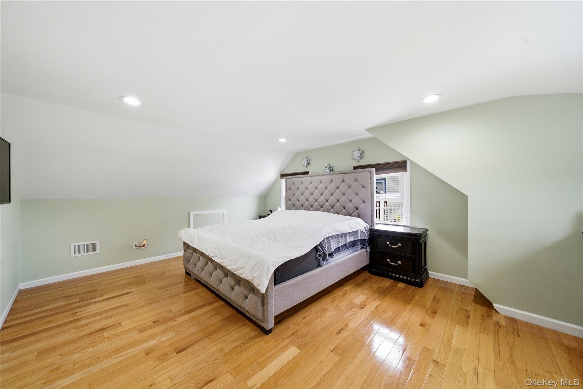 50 Ridge Lane Levittown, NY 11756 - Photo 16 of 27 a bedroom with a bed and window