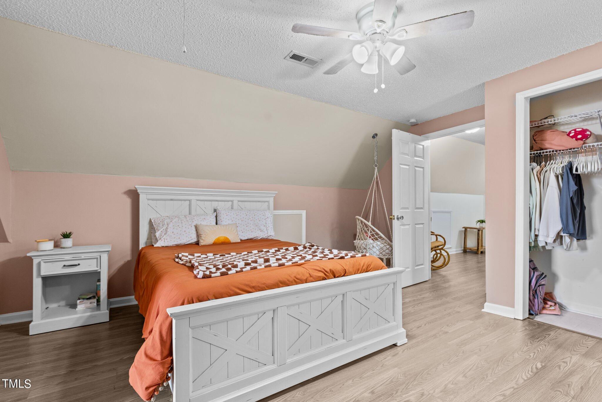 5321 Holland Church Road Raleigh, NC 27603 - Photo 29 of 43 a bedroom with a bed and a chandelier