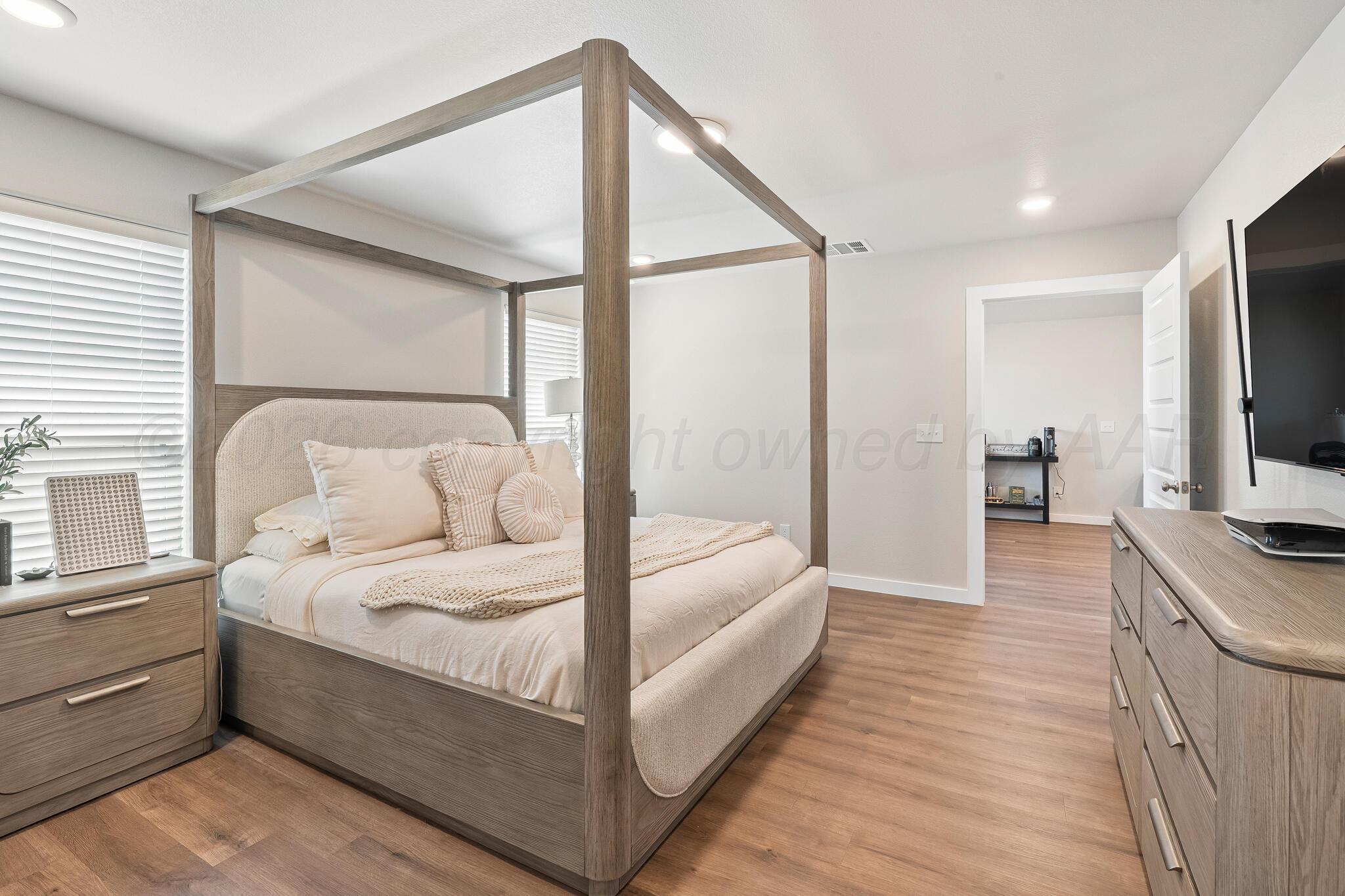 7500 Castleman Road Amarillo, TX 79119 - Photo 11 of 20 a bedroom with a bed and a flat screen tv