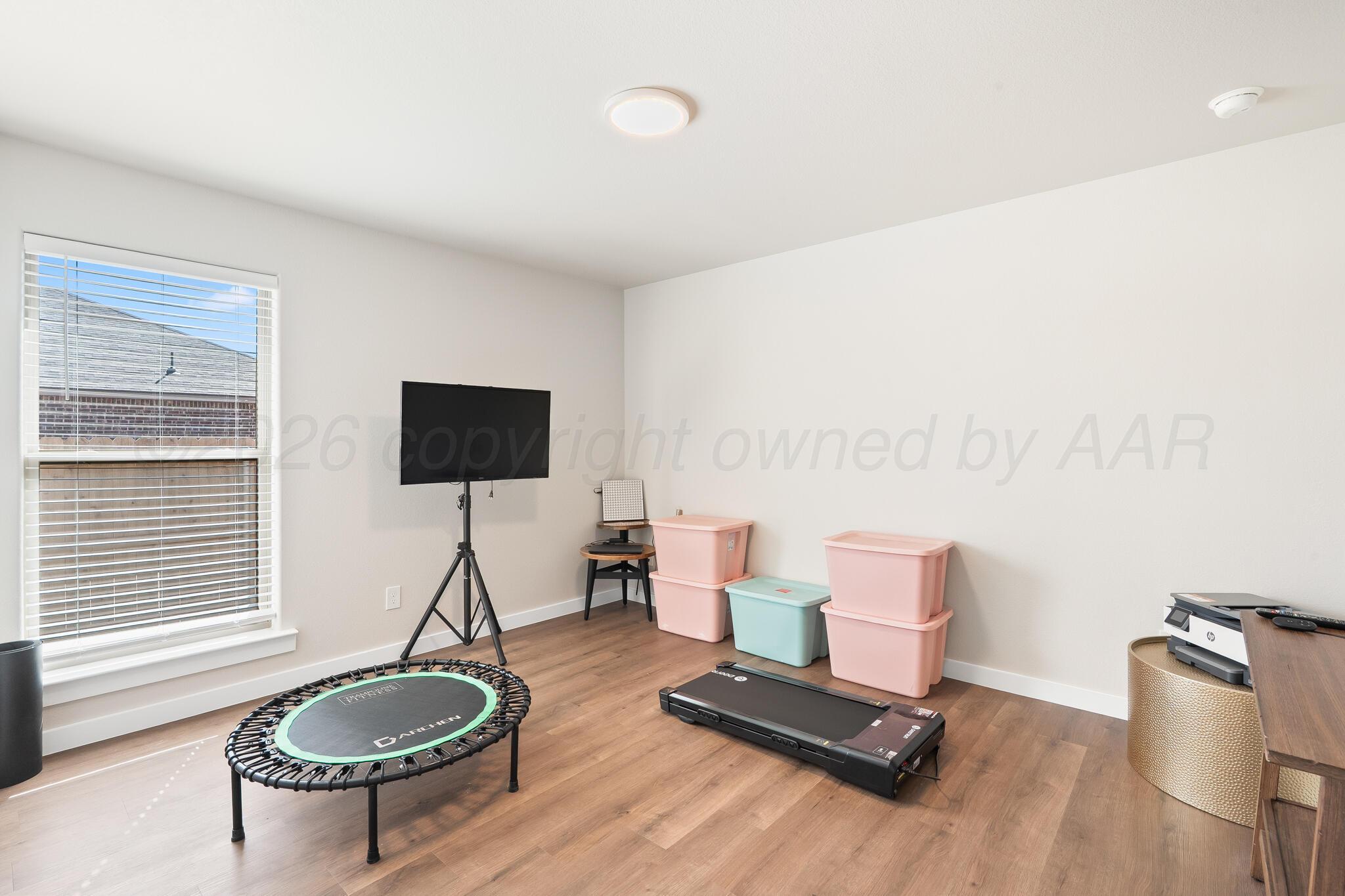 7500 Castleman Road Amarillo, TX 79119 - Photo 14 of 20 a living room with furniture a window and a flat screen tv