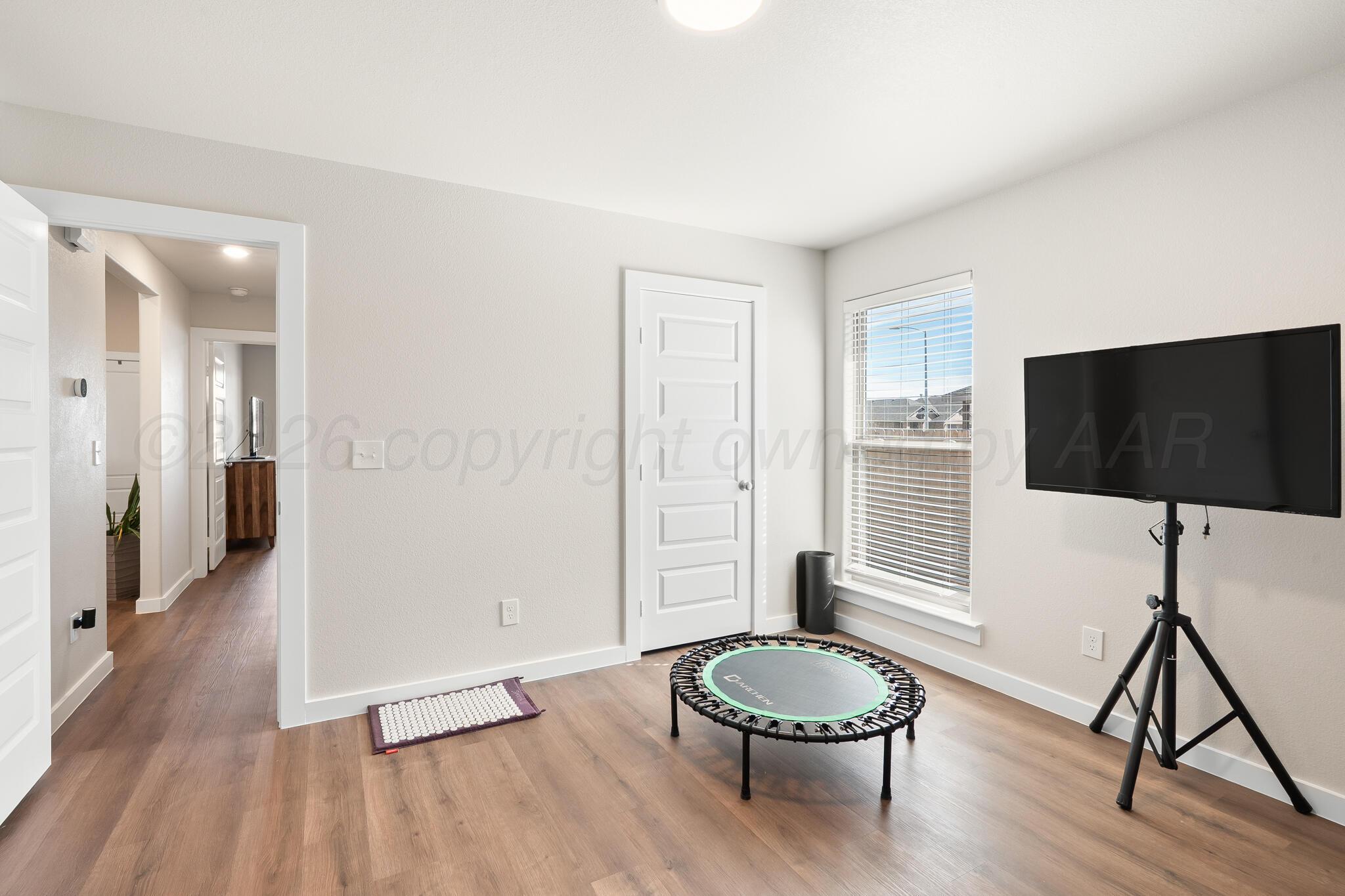 7500 Castleman Road Amarillo, TX 79119 - Photo 15 of 20 a living room with furniture and a flat screen tv