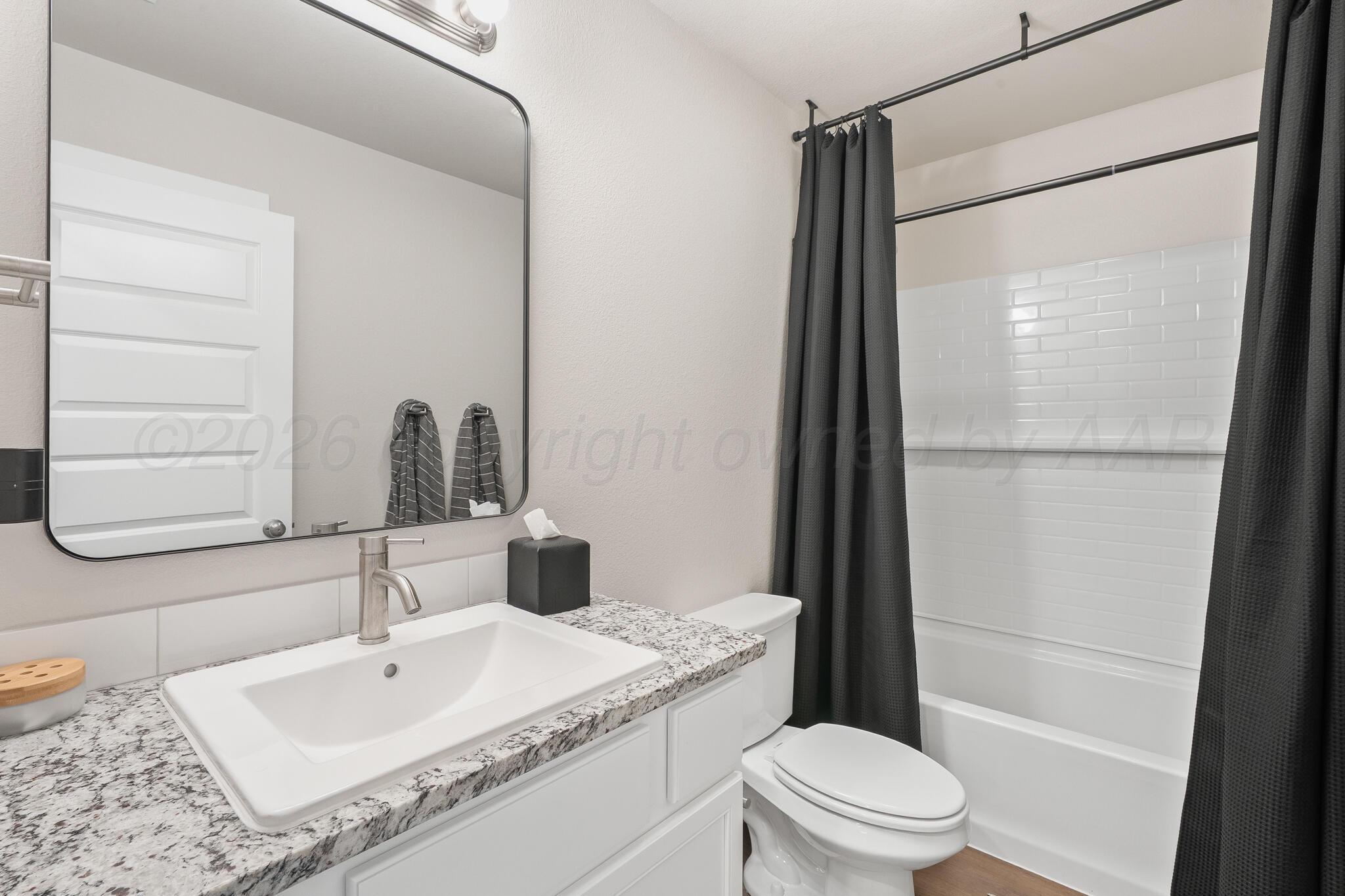 7500 Castleman Road Amarillo, TX 79119 - Photo 16 of 20 a bathroom with a sink a toilet and shower