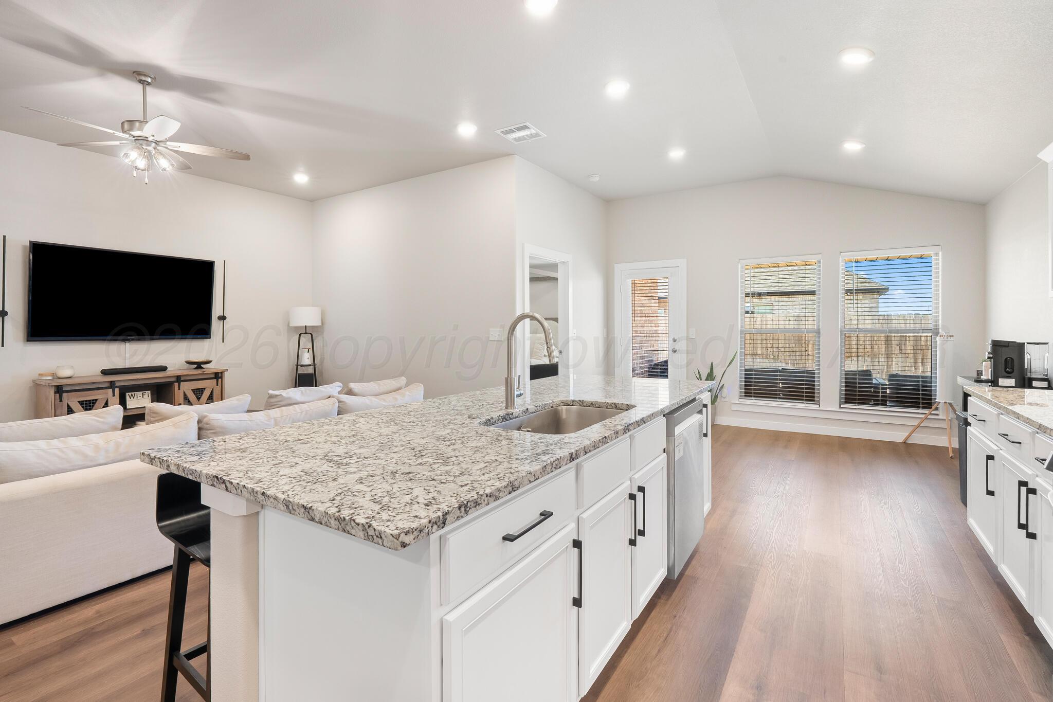 7500 Castleman Road Amarillo, TX 79119 - Photo 5 of 20 a kitchen with granite countertop a sink and a stove top oven