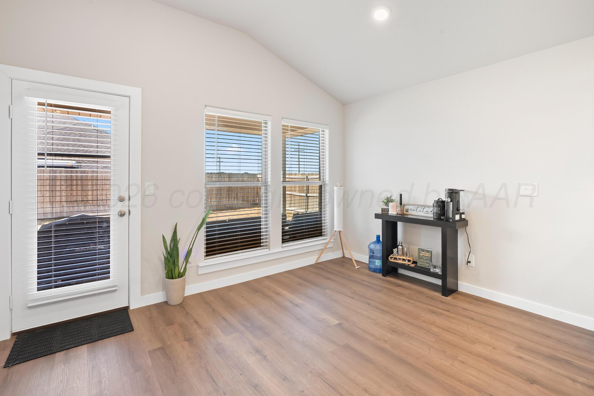 7500 Castleman Road Amarillo, TX 79119 - Photo 8 of 20 a view of a livingroom with wooden floor and a window