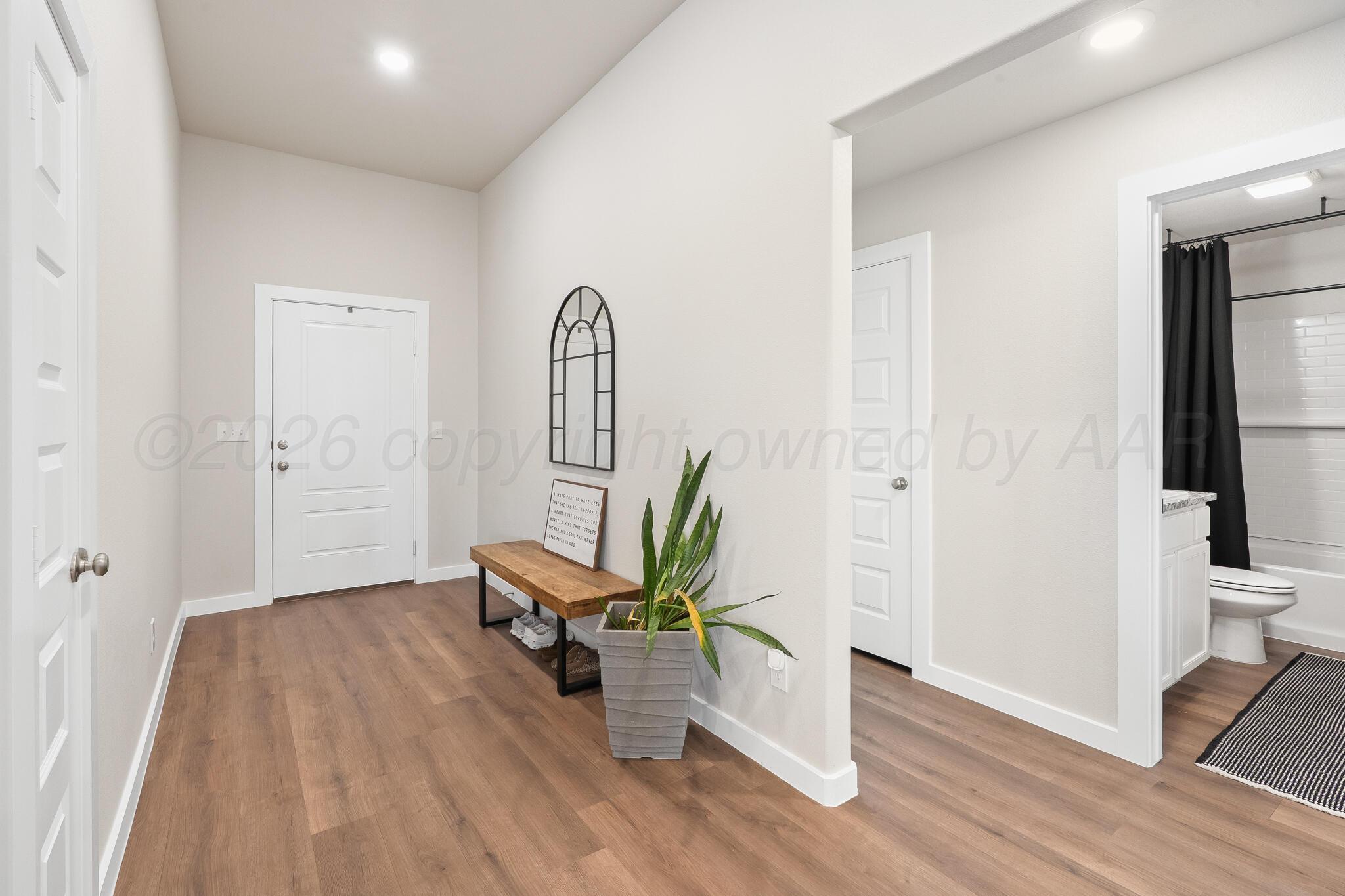 7500 Castleman Road Amarillo, TX 79119 - Photo 9 of 20 wooden floor in an empty room with a window