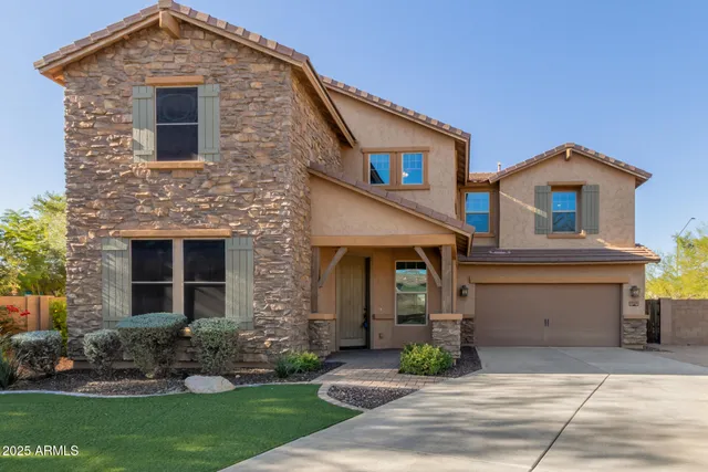 a front view of a house with a yard and garage