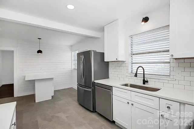 a kitchen with a sink and refrigerator