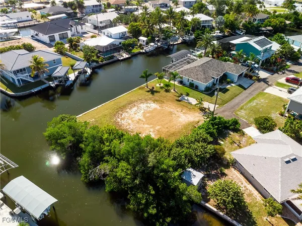 an aerial view of residential houses with outdoor space and lake view
