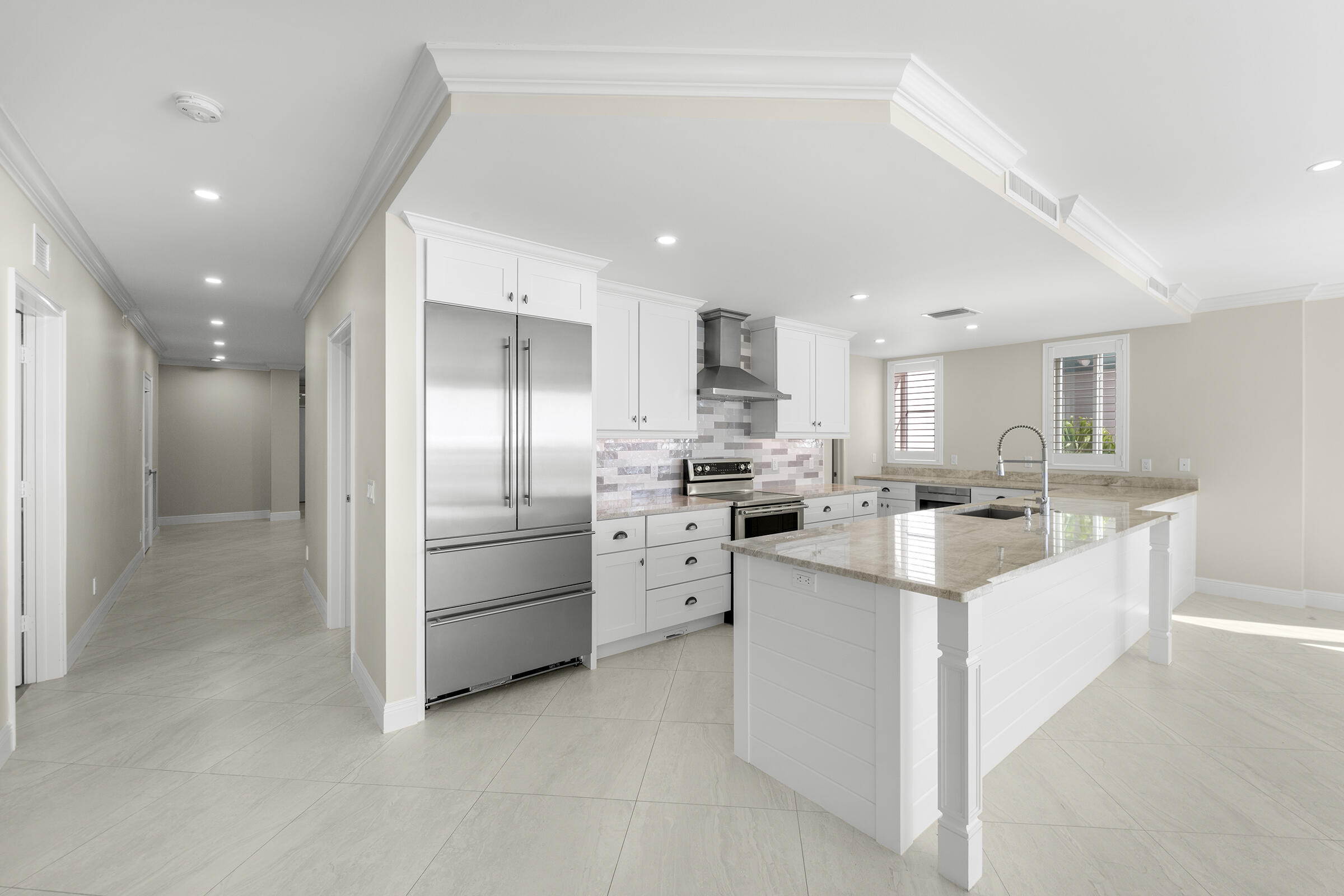 140 Inlet Way, Unit 312 Palm Beach Shores, FL 33404 - Photo 26 of 59 a kitchen with white cabinets and stainless steel appliances