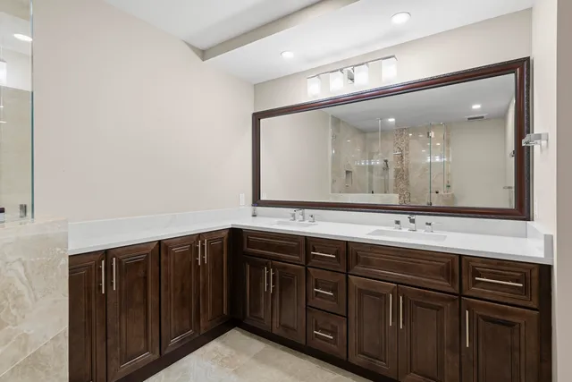 a bathroom with a sink toilet a mirror and shower