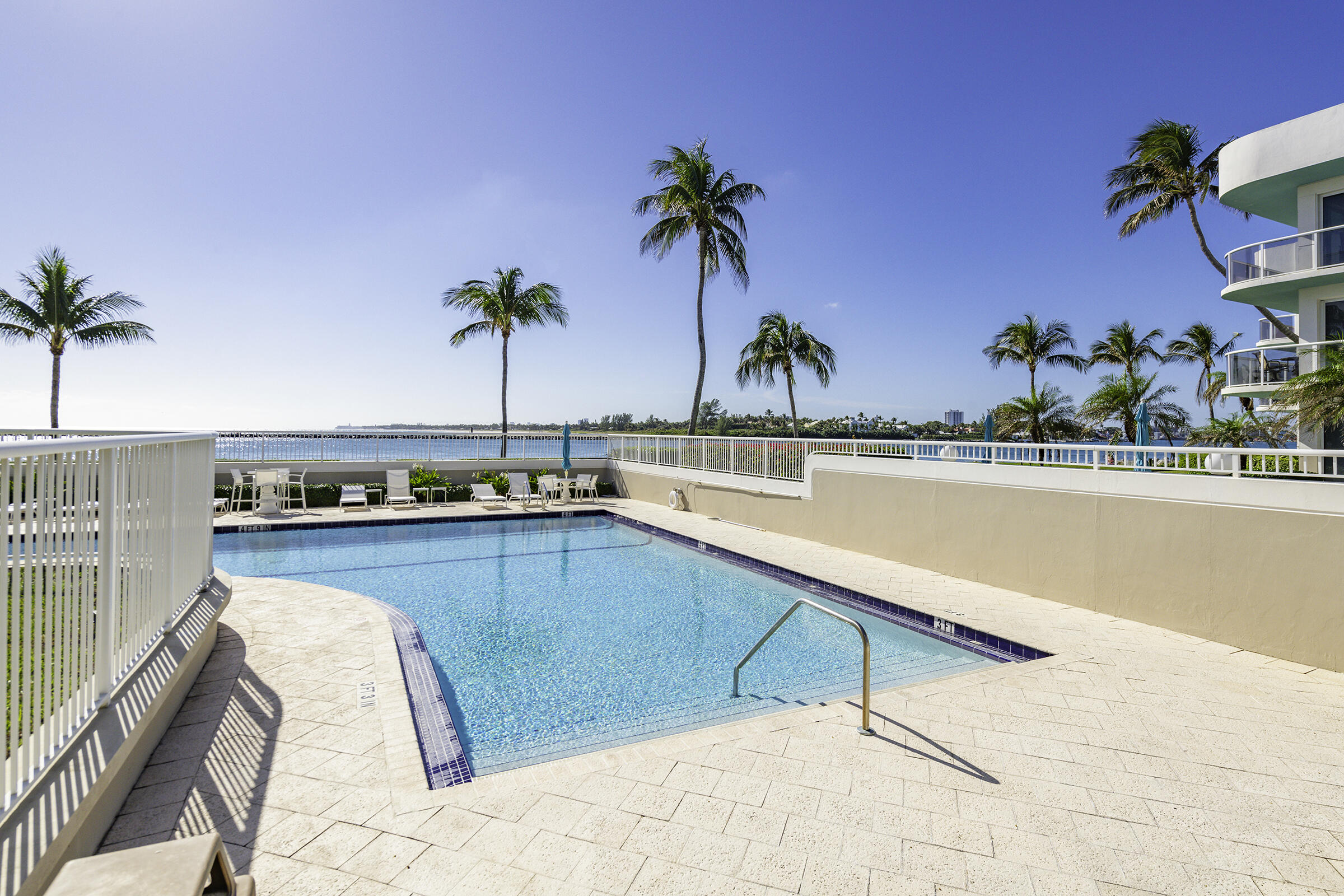 140 Inlet Way, Unit 312 Palm Beach Shores, FL 33404 - Photo 49 of 59 a view of a swimming pool and lounge chair