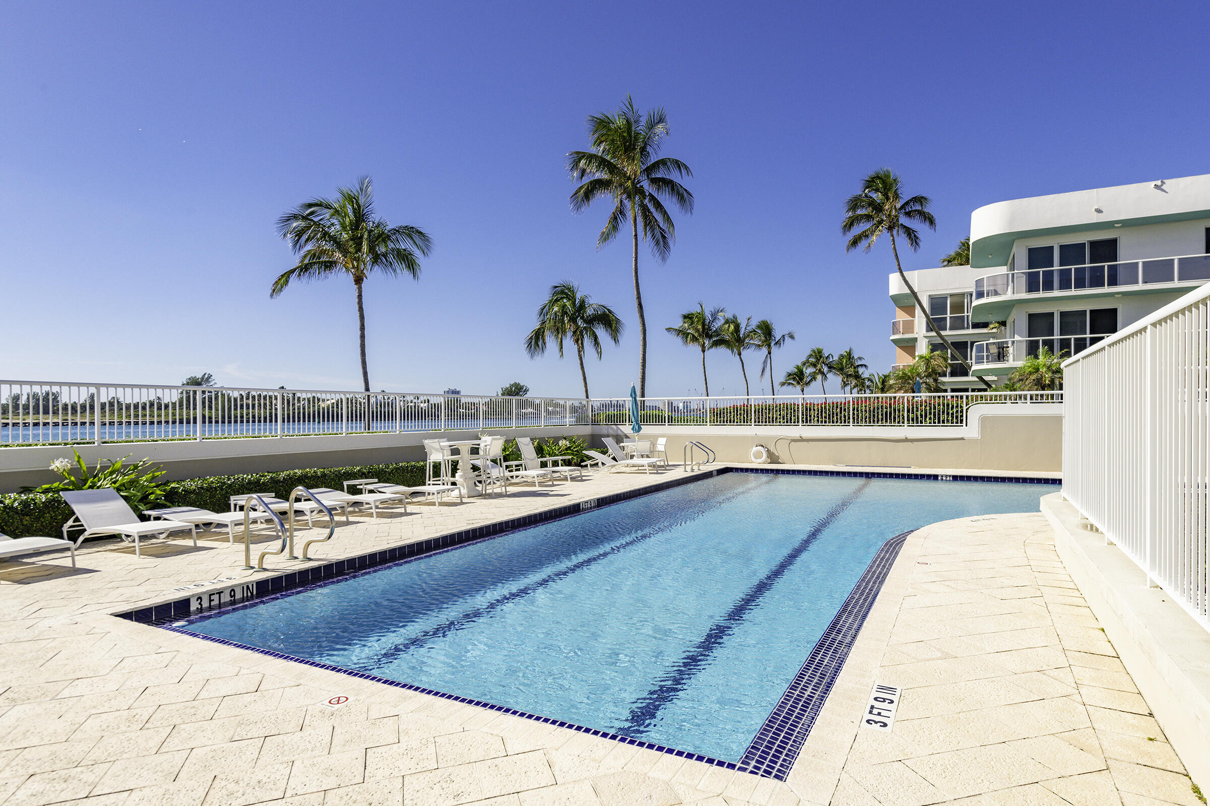 140 Inlet Way, Unit 312 Palm Beach Shores, FL 33404 - Photo 50 of 59 a view of swimming pool with outdoor seating and plants