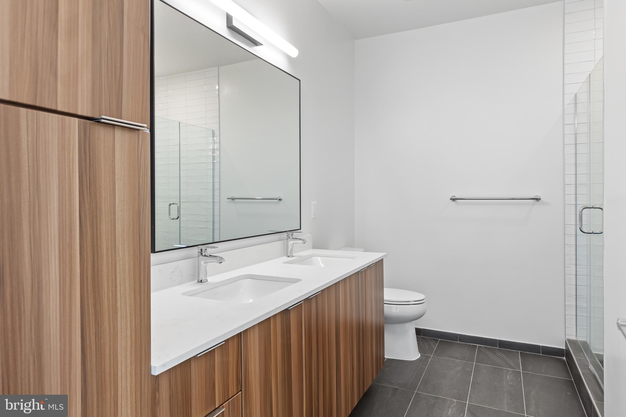 7175 12th Street Northwest, Unit 513 Washington, DC 20012 - Photo 8 of 31 a bathroom with a sink a toilet and shower