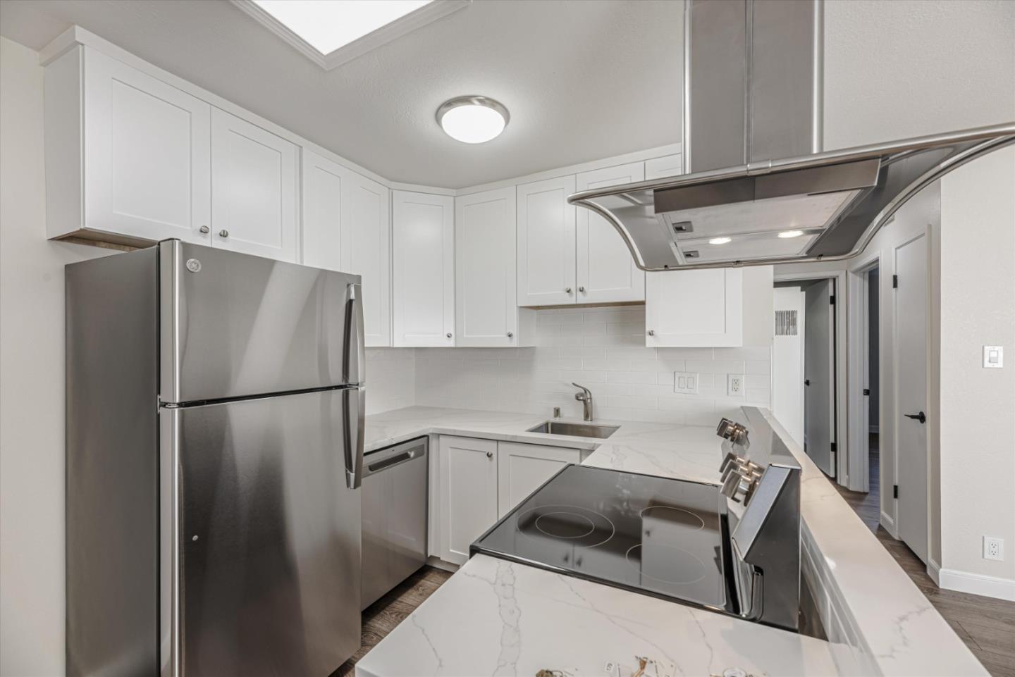 424 Richmond Drive Millbrae, CA 94030 - Photo 13 of 22 a kitchen with a refrigerator sink and cabinets