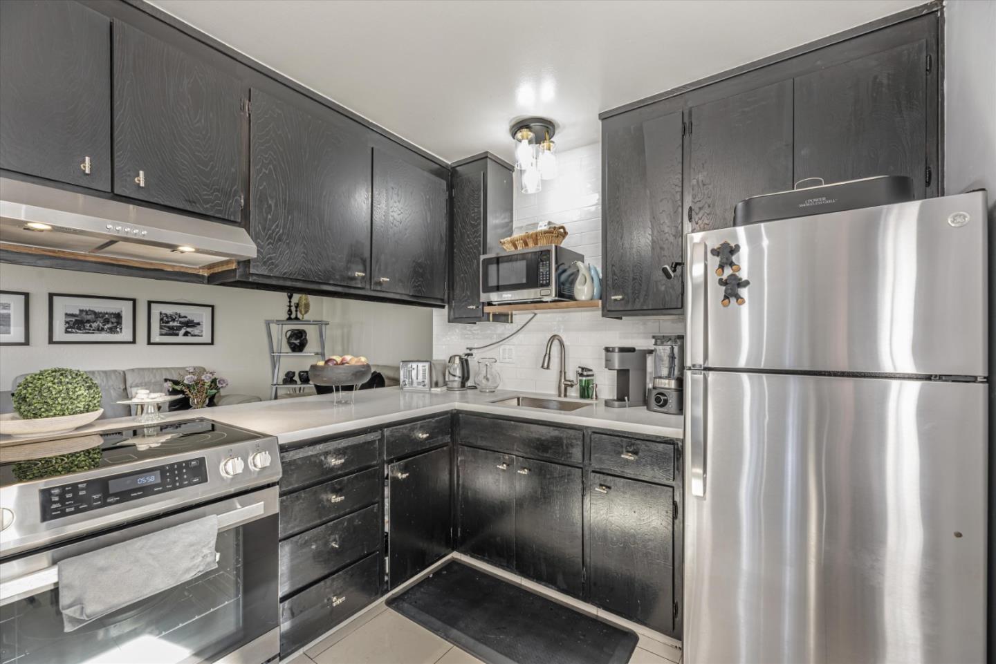 424 Richmond Drive Millbrae, CA 94030 - Photo 15 of 22 a kitchen with granite countertop stainless steel appliances a sink a stove and cabinets