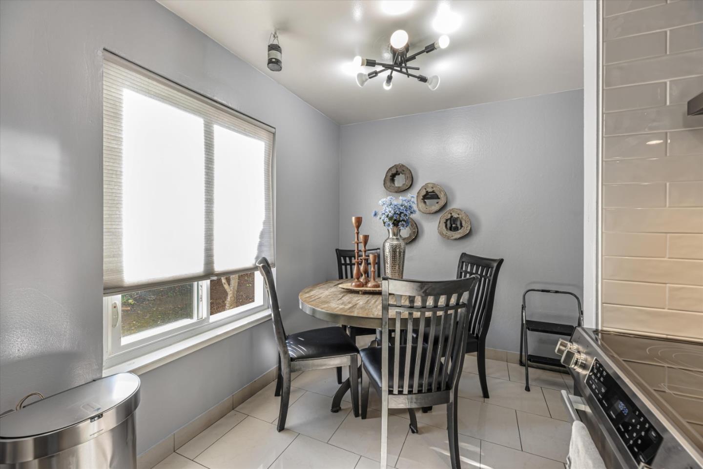 424 Richmond Drive Millbrae, CA 94030 - Photo 16 of 22 a view of a dining room with furniture and chandelier
