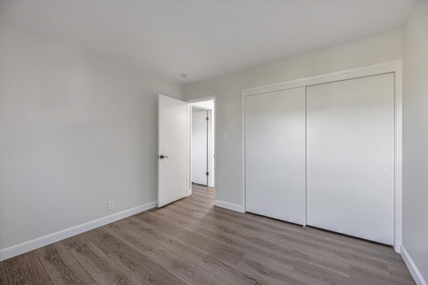 424 Richmond Drive Millbrae, CA 94030 - Photo 17 of 22 a view of an empty room with wooden floor