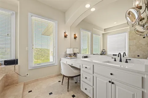 a bedroom with a bed a window and a chandelier