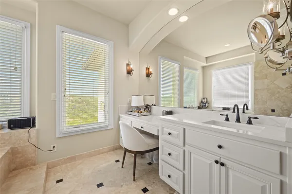 a bedroom with a bed a window and a chandelier
