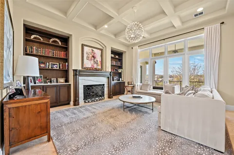 a kitchen that has a lot of white cabinets and stainless steel appliances