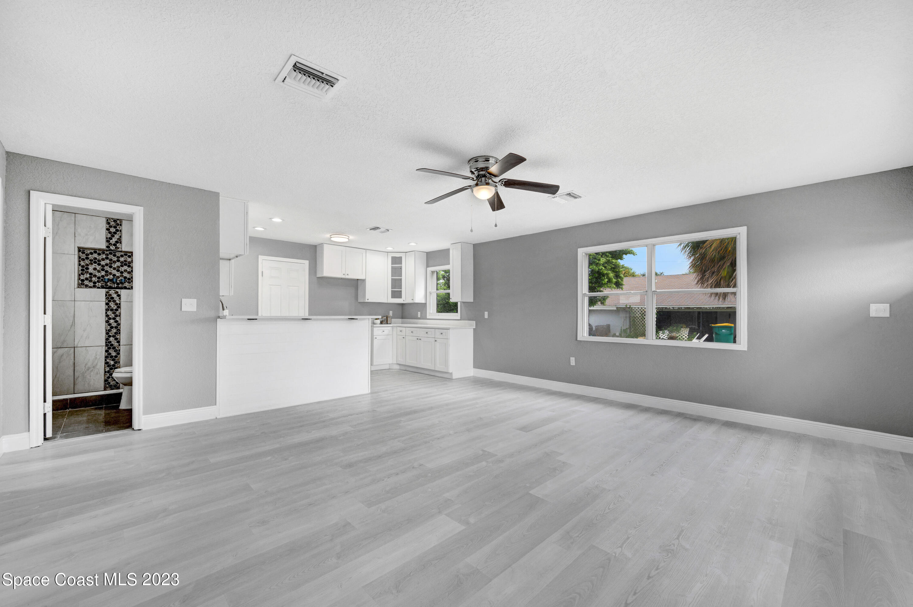 2114 King Richard Road Melbourne, FL 32935 - Photo 7 of 24 a view of a kitchen with a sink cabinets and a window