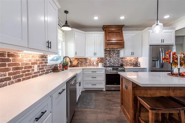 a kitchen with a sink stove and cabinets