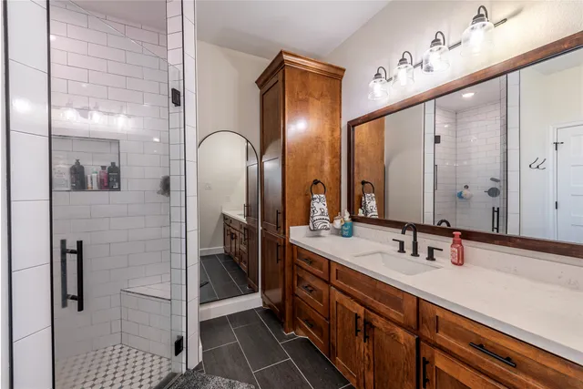 a bathroom with a double vanity sink and a mirror