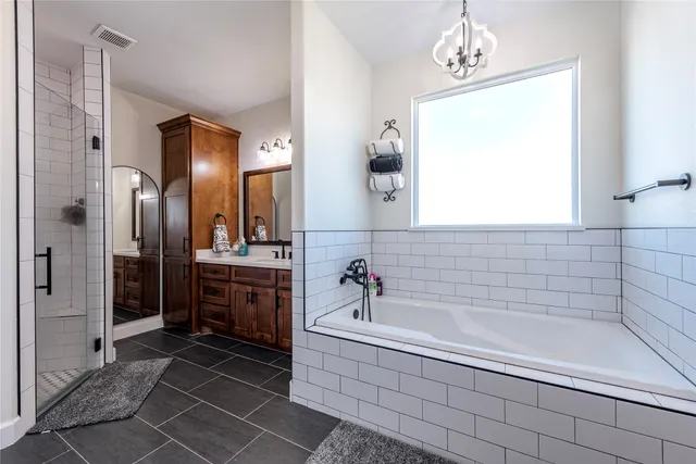 a spacious bathroom with a bathtub and a shower