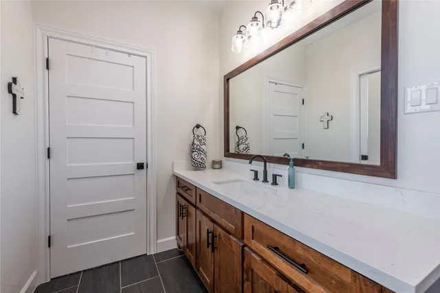 a bathroom with a sink a vanity and a mirror
