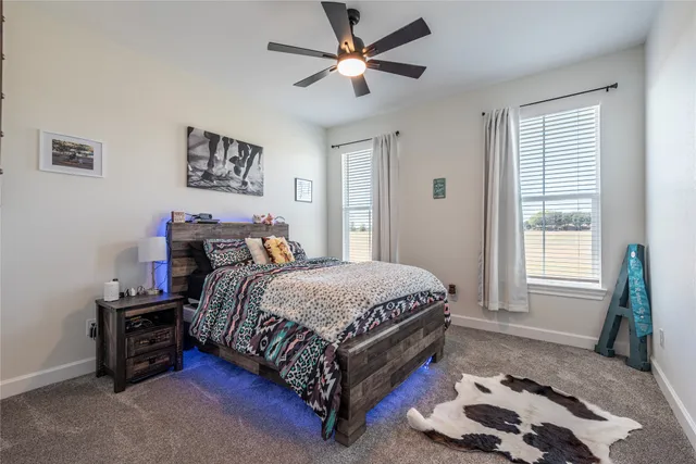 a bedroom with a bed a dresser and a window