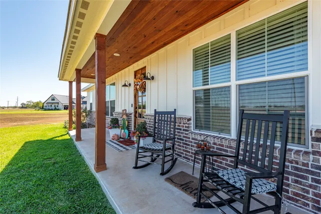 a view of a patio with chairs and table in patio