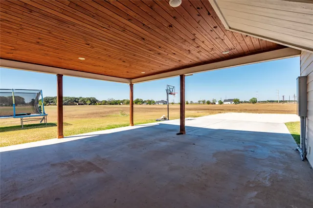 a view of an empty room with glass door