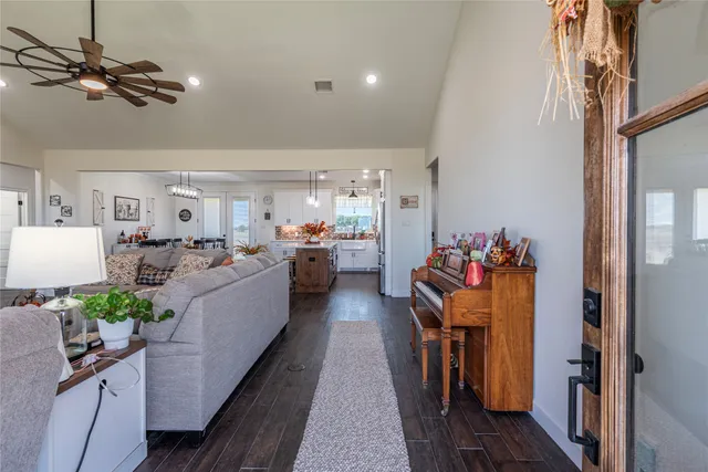 a living room with furniture and a chandelier