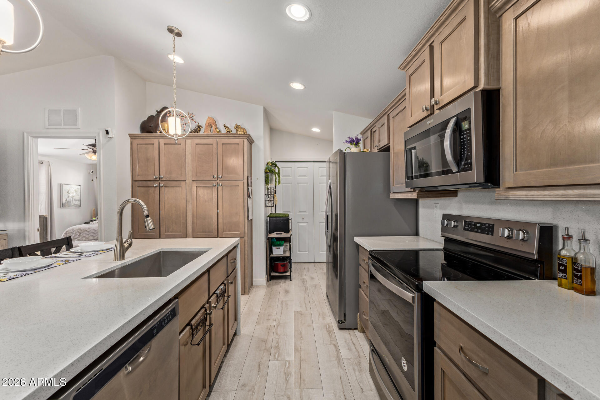 1101 South Ellsworth Road, Unit 153 Mesa, AZ 85208 - Photo 12 of 24 a kitchen with stainless steel appliances granite countertop a sink stove and refrigerator