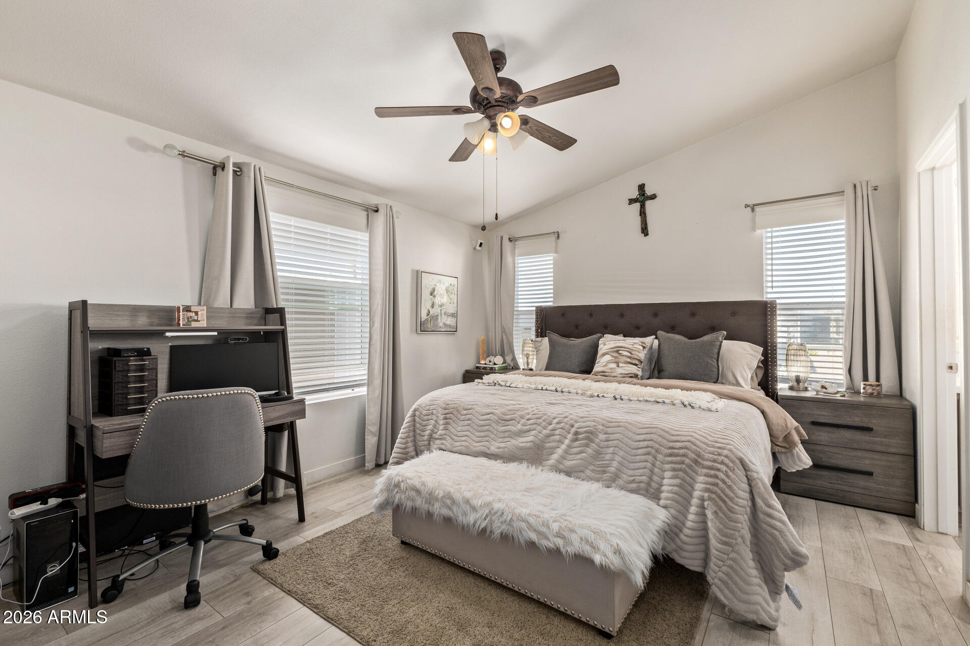 1101 South Ellsworth Road, Unit 153 Mesa, AZ 85208 - Photo 13 of 24 a bedroom with a bed a desk and chair with wooden floor