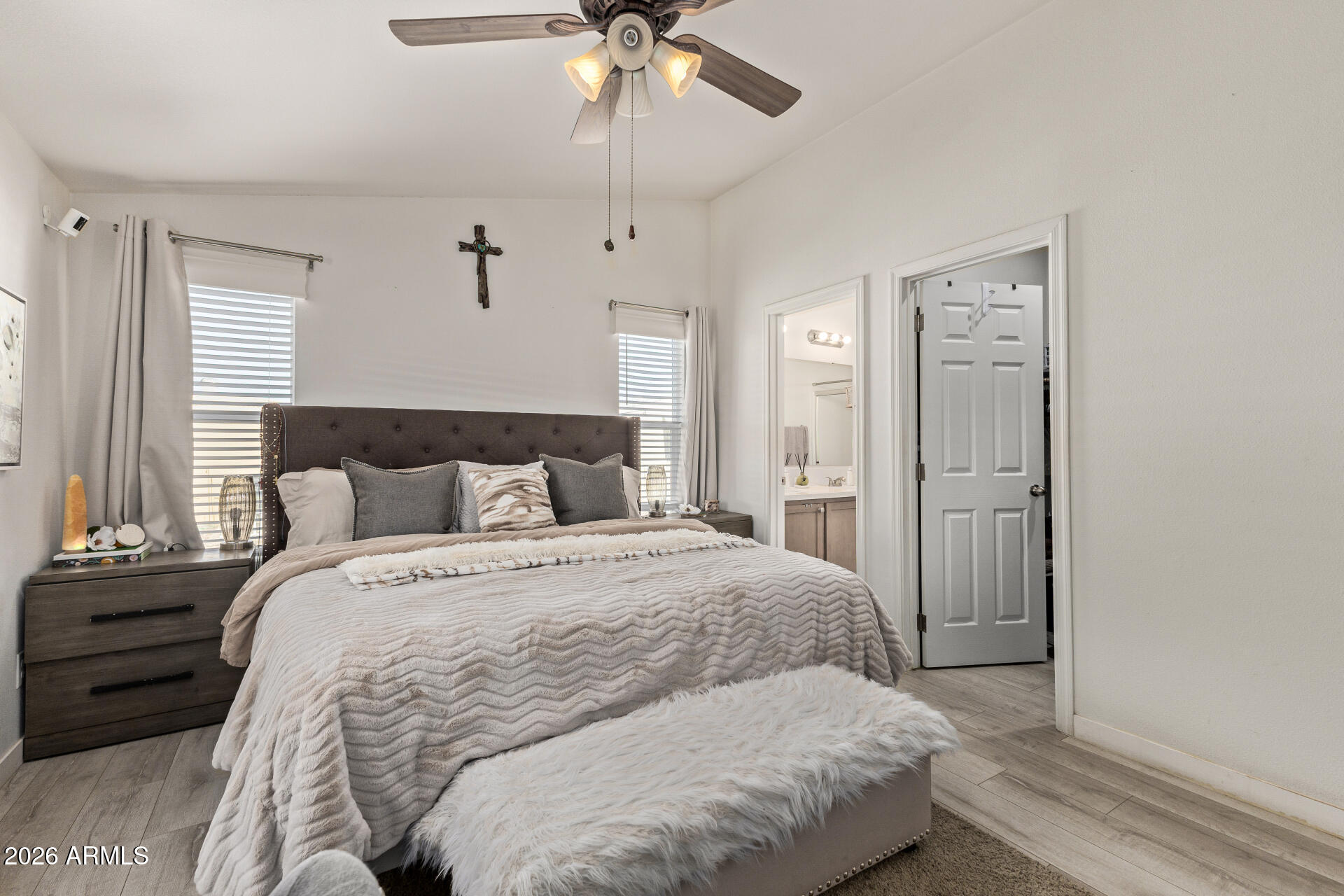 1101 South Ellsworth Road, Unit 153 Mesa, AZ 85208 - Photo 14 of 24 a bedroom with a large bed and a chandelier
