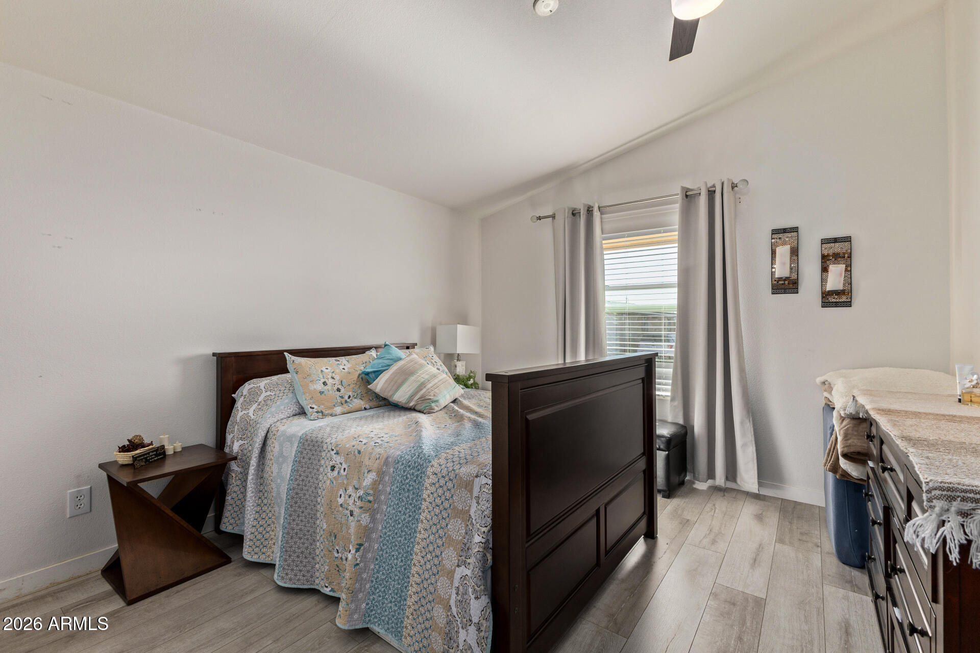 1101 South Ellsworth Road, Unit 153 Mesa, AZ 85208 - Photo 16 of 24 a bedroom with a bed and a flat tv screen on a dresser