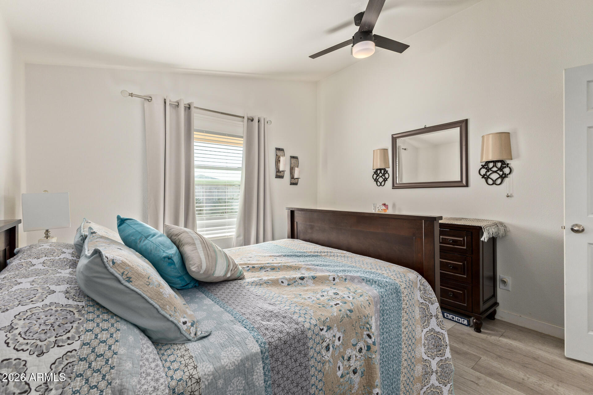 1101 South Ellsworth Road, Unit 153 Mesa, AZ 85208 - Photo 17 of 24 a bedroom with a bed and wooden floor