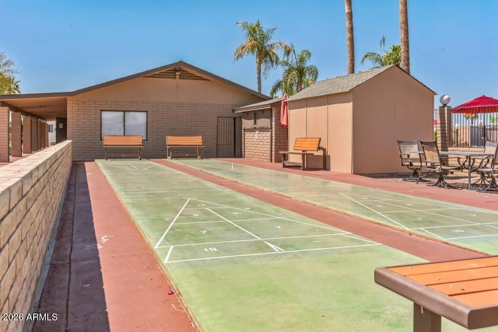 1101 South Ellsworth Road, Unit 153 Mesa, AZ 85208 - Photo 21 of 24 a view of a house with a backyard and a garage
