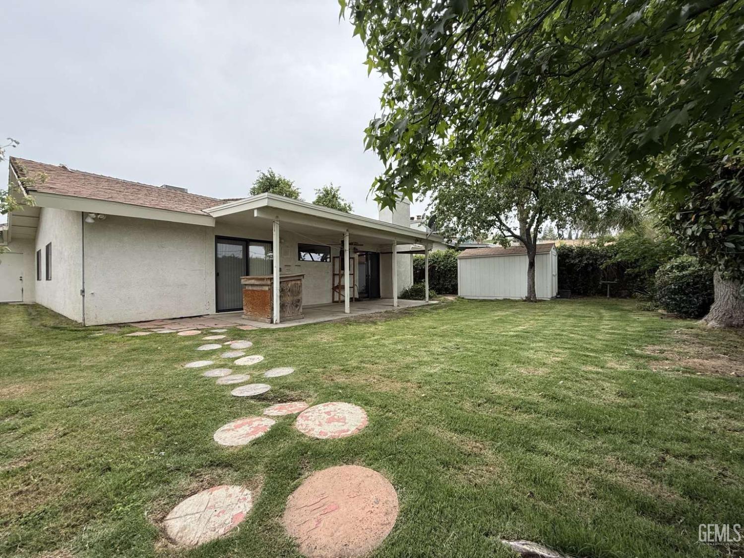 Undisclosed Address Bakersfield, CA 93306 - Photo 3 of 3 a view of a white house with a sink and a yard