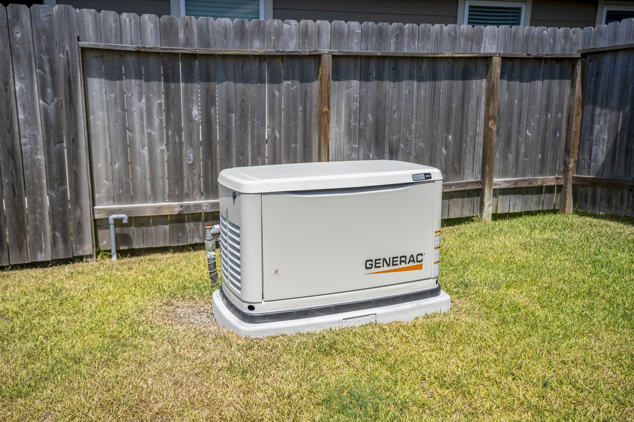 2355 Mount Locke Path Conroe, TX 77301 - Photo 43 of 47 One of the home’s standout practical upgrades sits right here in the backyard: an 18 KW standby generator, adding an extra layer of peace of mind during Houston’s unpredictable seasons and in case of power outages.
