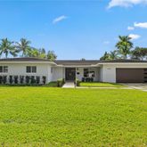 a front view of a house with swimming pool having outdoor seating