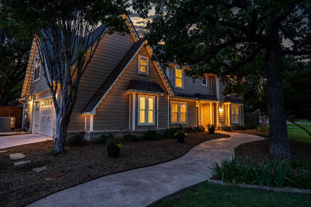 410 Simmons Road Double Oak, TX 75077 - Photo 6 of 40 Gorgeous evening lighting showcases the home and landscaping.