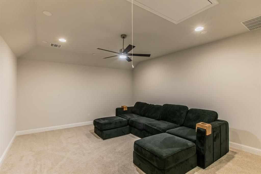 16833 Chapel Road Lorena, TX 76655 - Photo 20 of 40 a living room with furniture and a ceiling fan