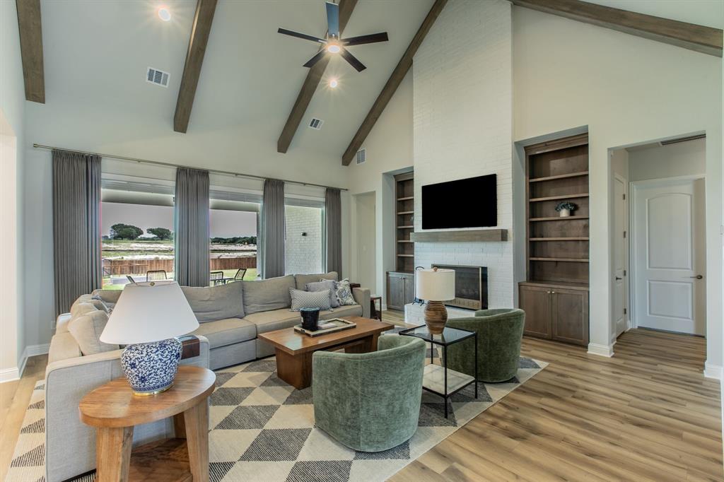 16833 Chapel Road Lorena, TX 76655 - Photo 2 of 40 a living room with furniture a fireplace and a flat screen tv