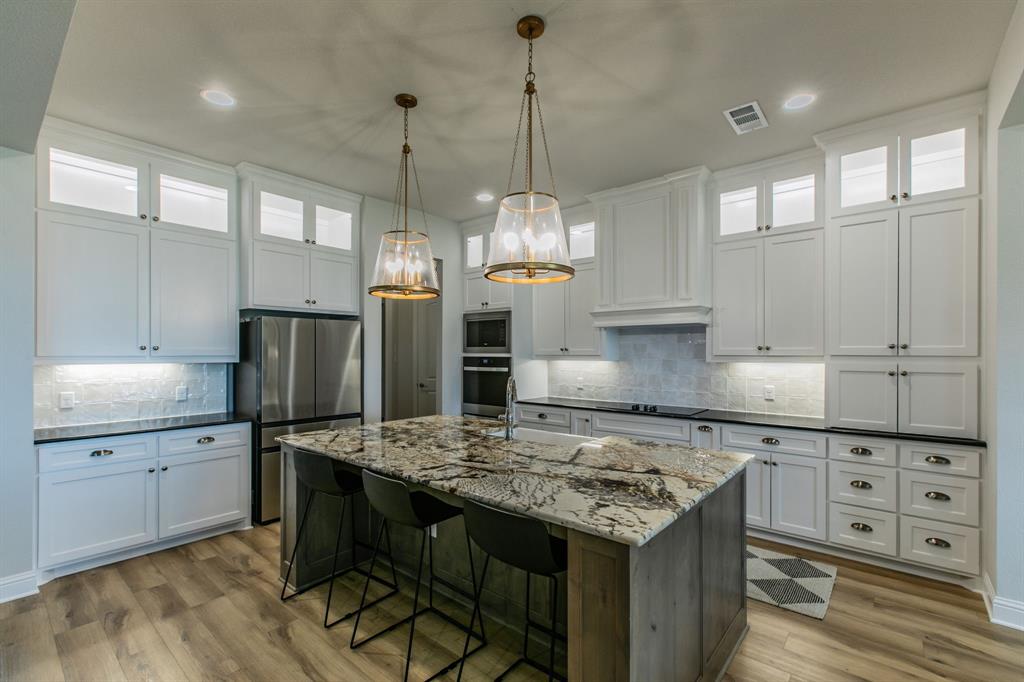 16833 Chapel Road Lorena, TX 76655 - Photo 5 of 40 a kitchen with kitchen island granite countertop a sink stove and refrigerator